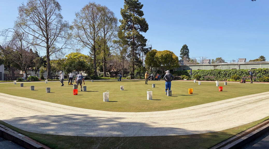 Volunteers with sand buckets on the BLBC green